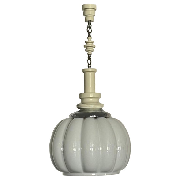 A white Murano glass pendant lamp with chrome details and woodwork attachments, featuring a ribbed design and a chain for hanging.