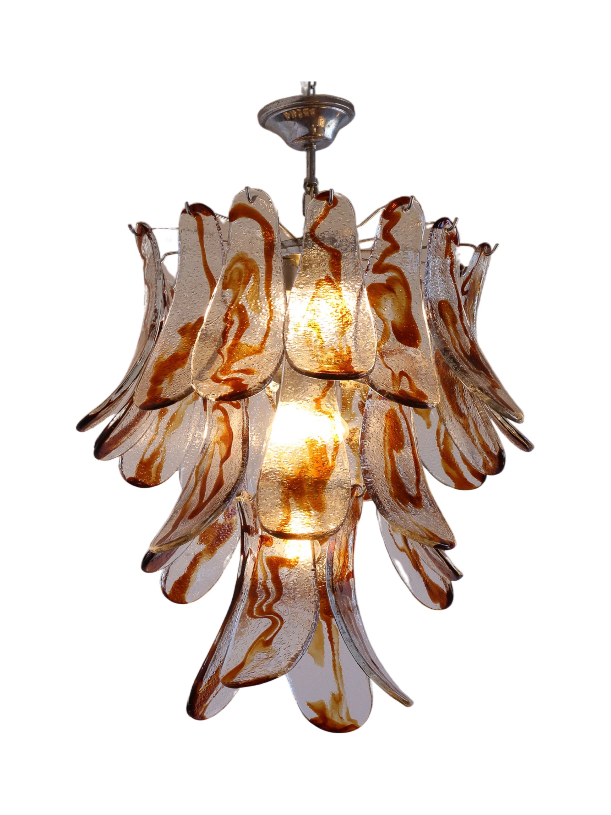 An amber Murano glass and chrome pendant light fixture, with multiple curved glass pieces around a central light source.