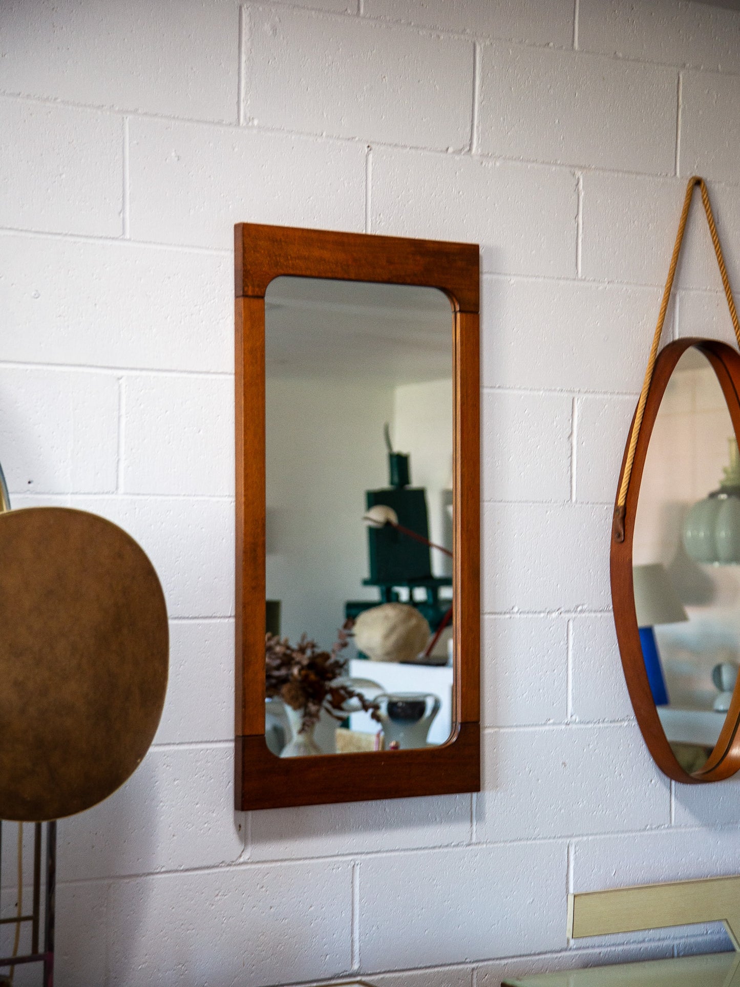 Wooden mirrors on a white tiled wall