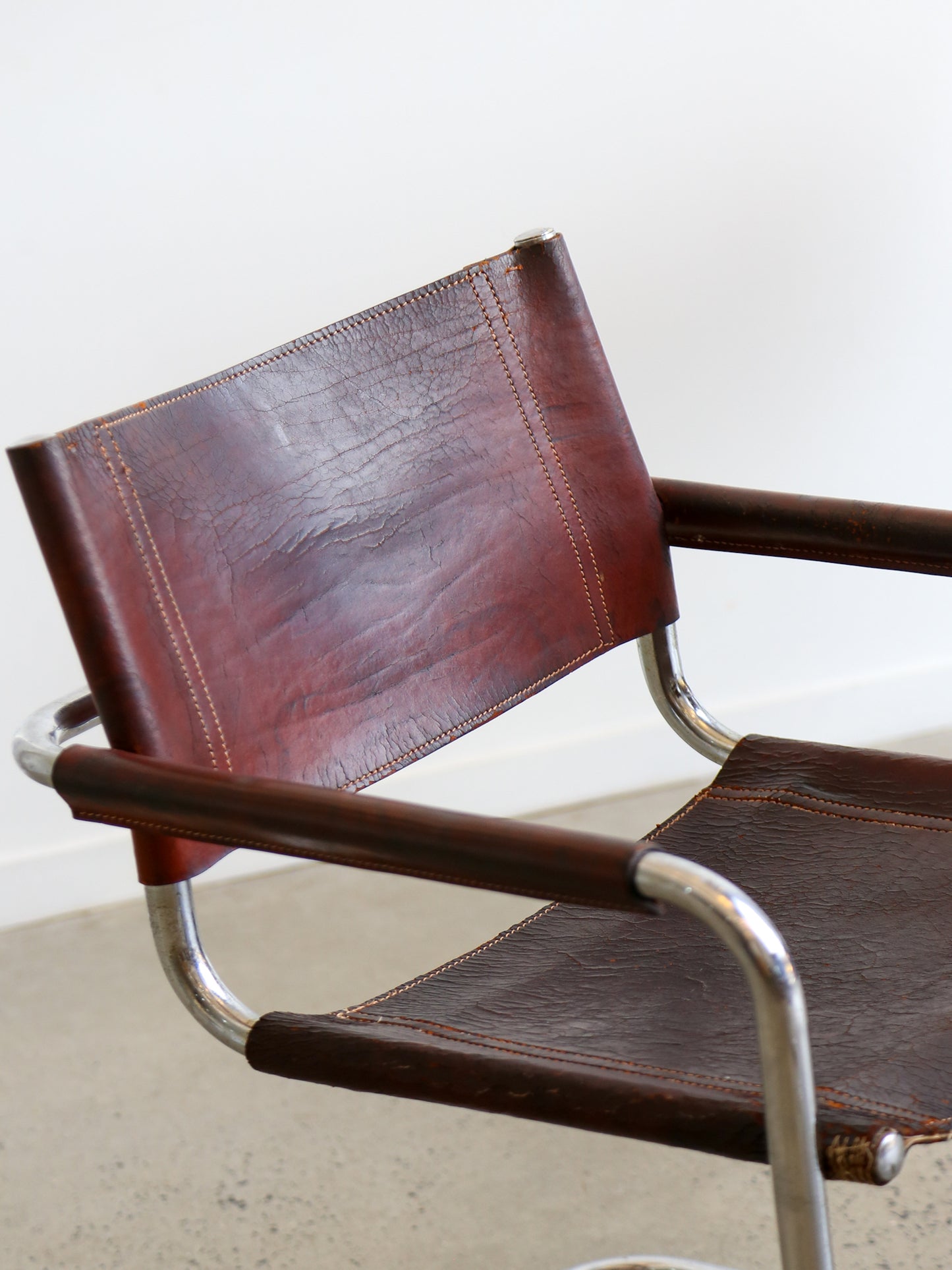 Close-up of Marcel Breuer S34 chair, 1970s, in brown leather with tubular chrome frame.