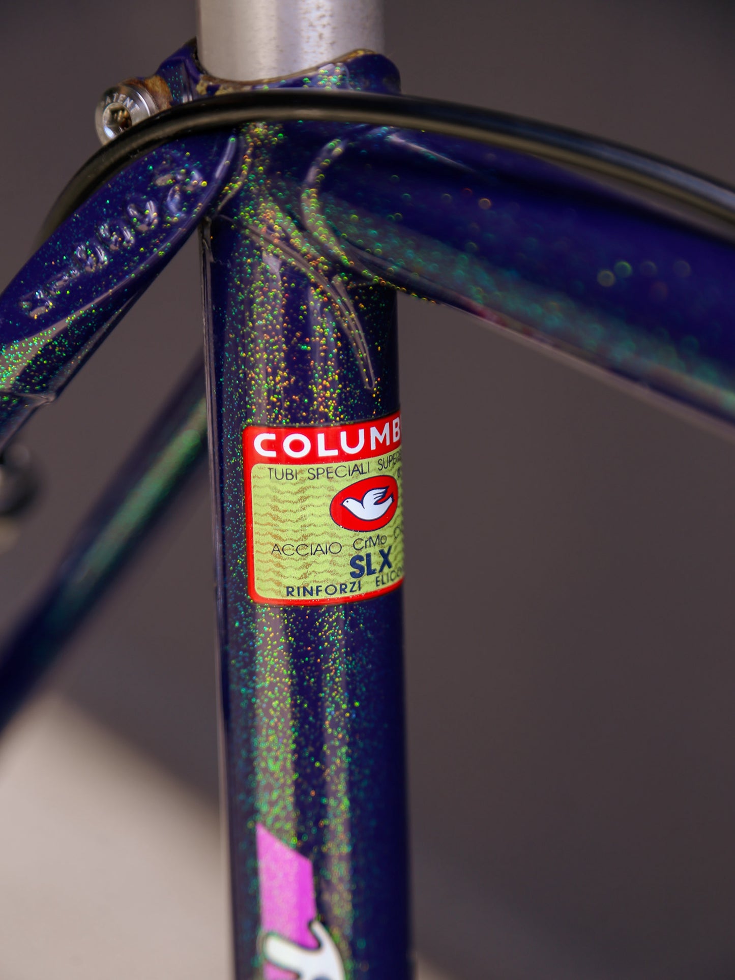 Close-up of a bicycle frame with Columbus branding on a blurred background