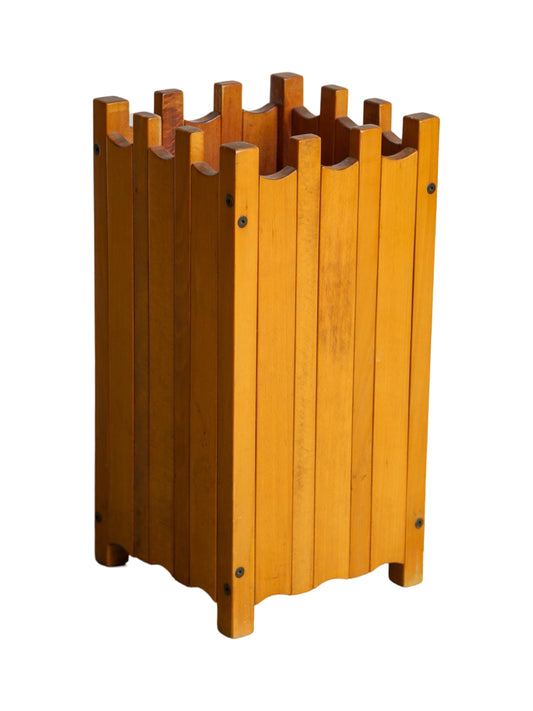 A wooden umbrella stand designed by Ettore Sottsass for Poltronova, featuring a geometric pattern of vertical and horizontal wooden slats.