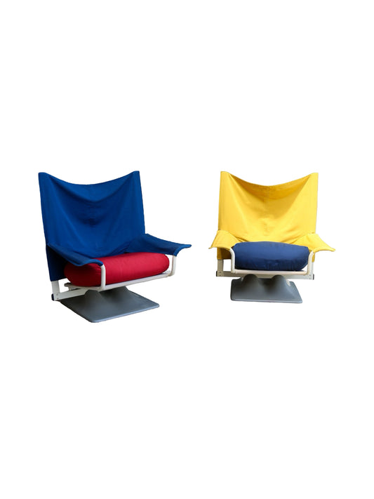 Two Aeo armchairs designed by Paolo Deganello, one in blue and one in yellow, with red seats, against a white background.
