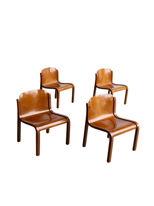 A set of four mid-century modern Mito chairs with a plywood structure and metal frame, upholstered in brown material.