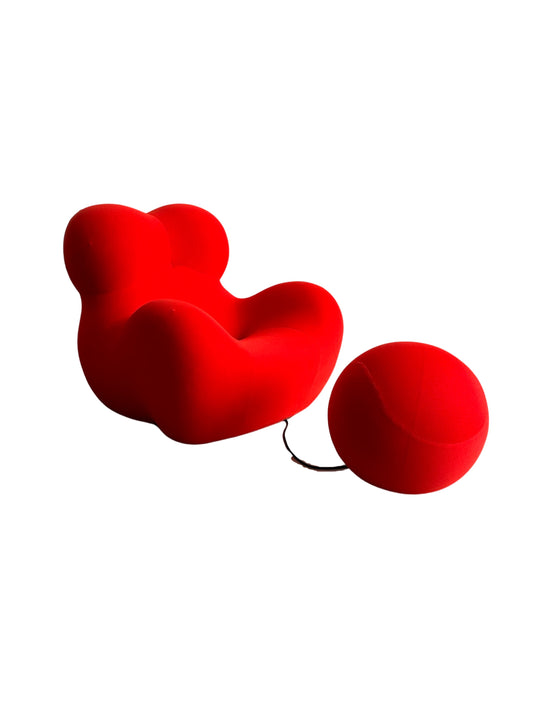 UP5 A red upholstered armchair with an abstracted female form and a spherical ottoman attached by a rubber cord by Gaetano Pesce