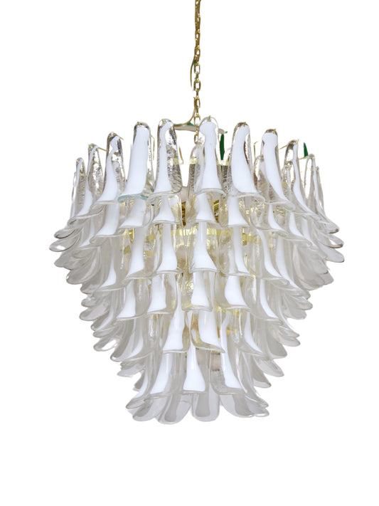A Murano glass chandelier with a gold-coated metal frame, featuring multiple levels of glass saddles and internal light bulbs, hangs from a gold chain.