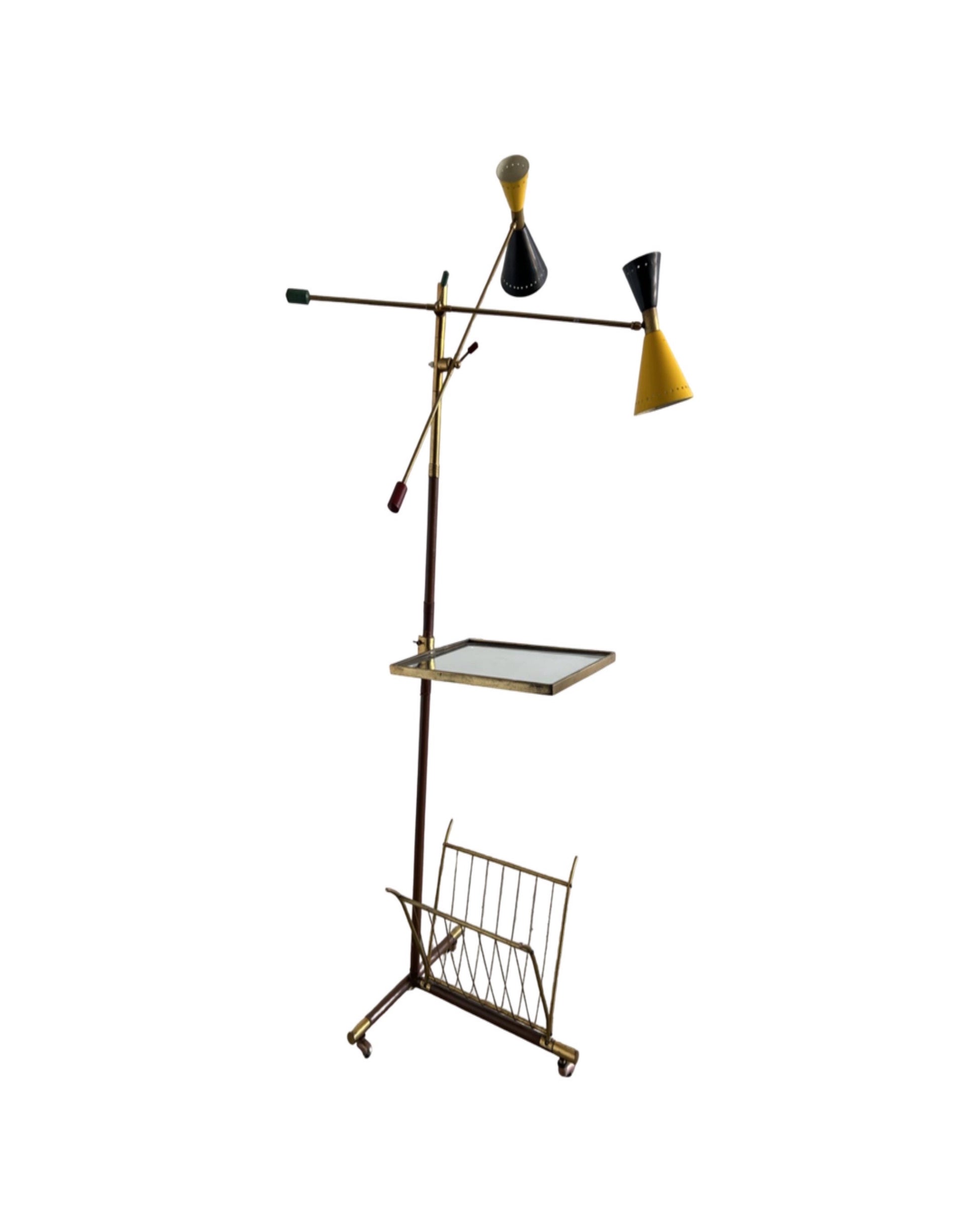 A vintage floor lamp by Angelo Lelli for Stilnovo with a brass structure, glass table, and leather covering. It features adjustable arms and a sculptural base.