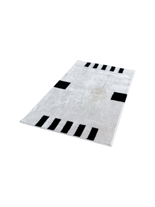 A black and white geometric designed cotton rug by Dieter Sieger for Gebhan Edition.