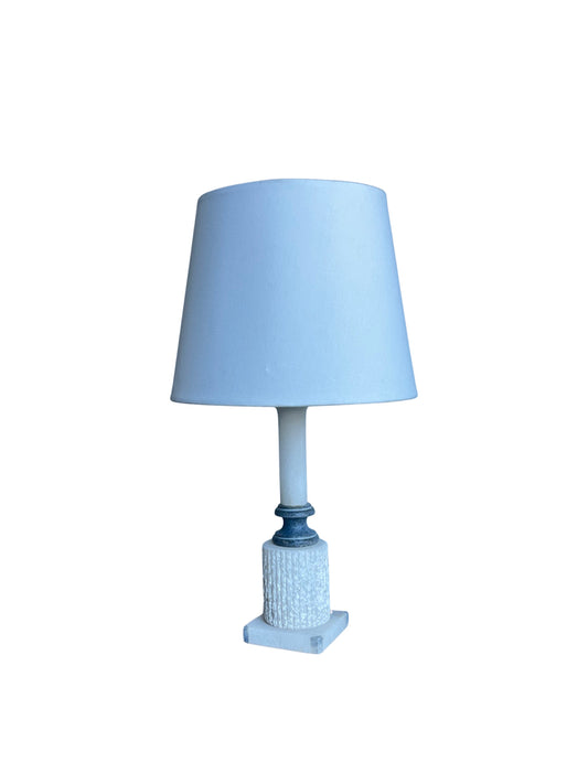 An Italian white marble table lamp with a blue lampshade, featuring a two-tone marble base.
