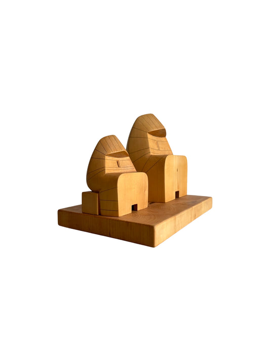 A lime wood sculpture by Giuseppe Rivadossi, featuring a geometric design with a smooth, polished finish.