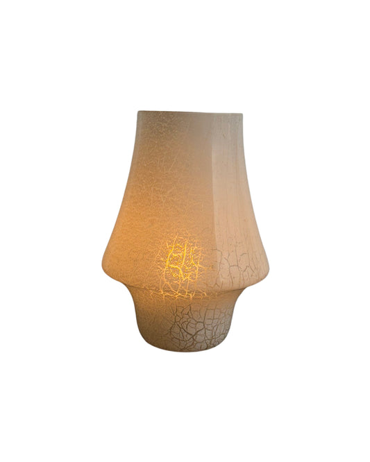 A white Murano glass mushroom-shaped table lamp with a visible flame, crafted by Paolo Venini, with a textured surface and a rounded shade.