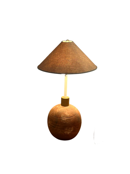 A terracotta by Impruneta Firenze  ceramic floor lamp with a spherical shape and a chrome base, featuring small perforations on the shade.