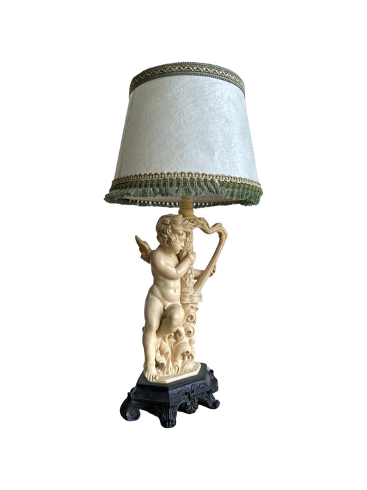 A resin table lamp base with a sculptural element on top, featuring a white lampshade with a decorative trim by Santini in Tuscany