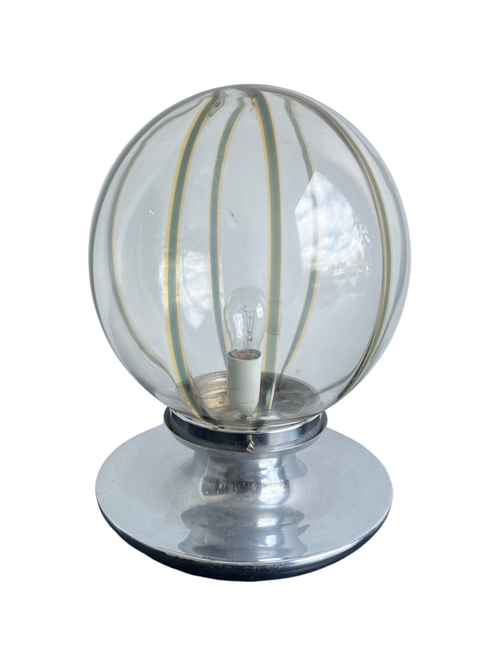A Mid-Century Modern table lamp with a spherical Murano glass shade and a chrome base by Toni Zuccheri