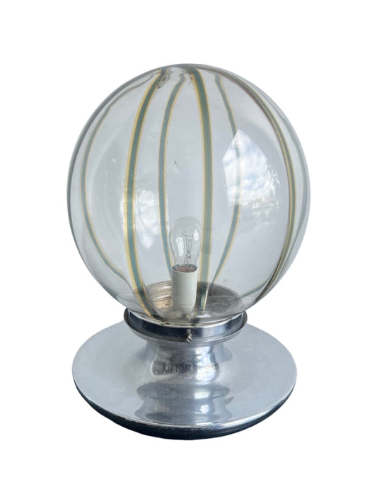 A Mid-Century Modern table lamp with a spherical Murano glass shade and a chrome base by Toni Zuccheri