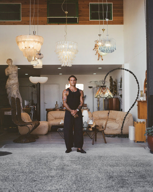 man standing in front of a decorated showroom