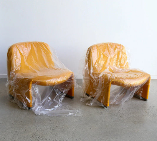 two yellow chairs wrapped in plastic