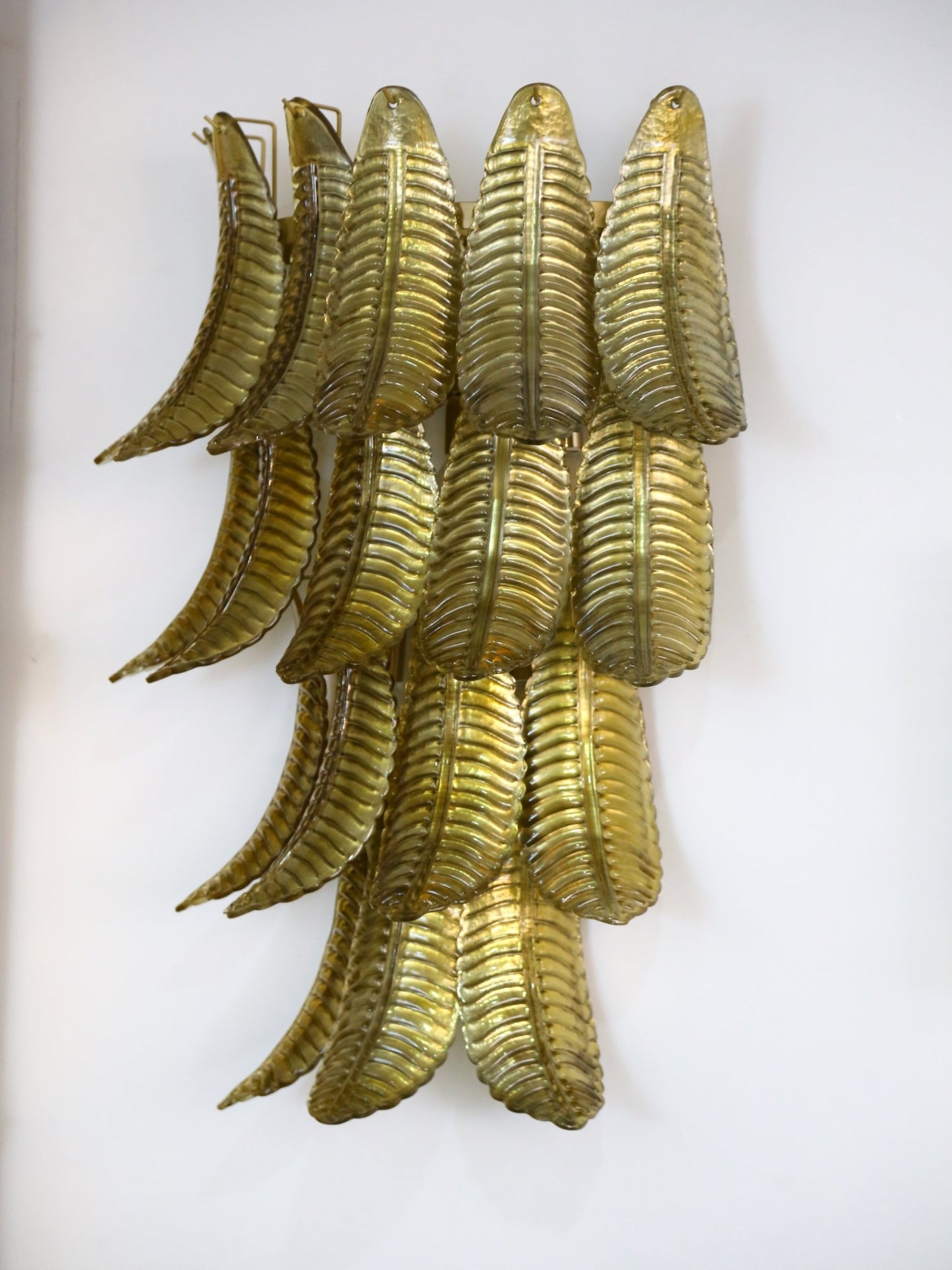 Decorative wall art with gold leaf design on a white background