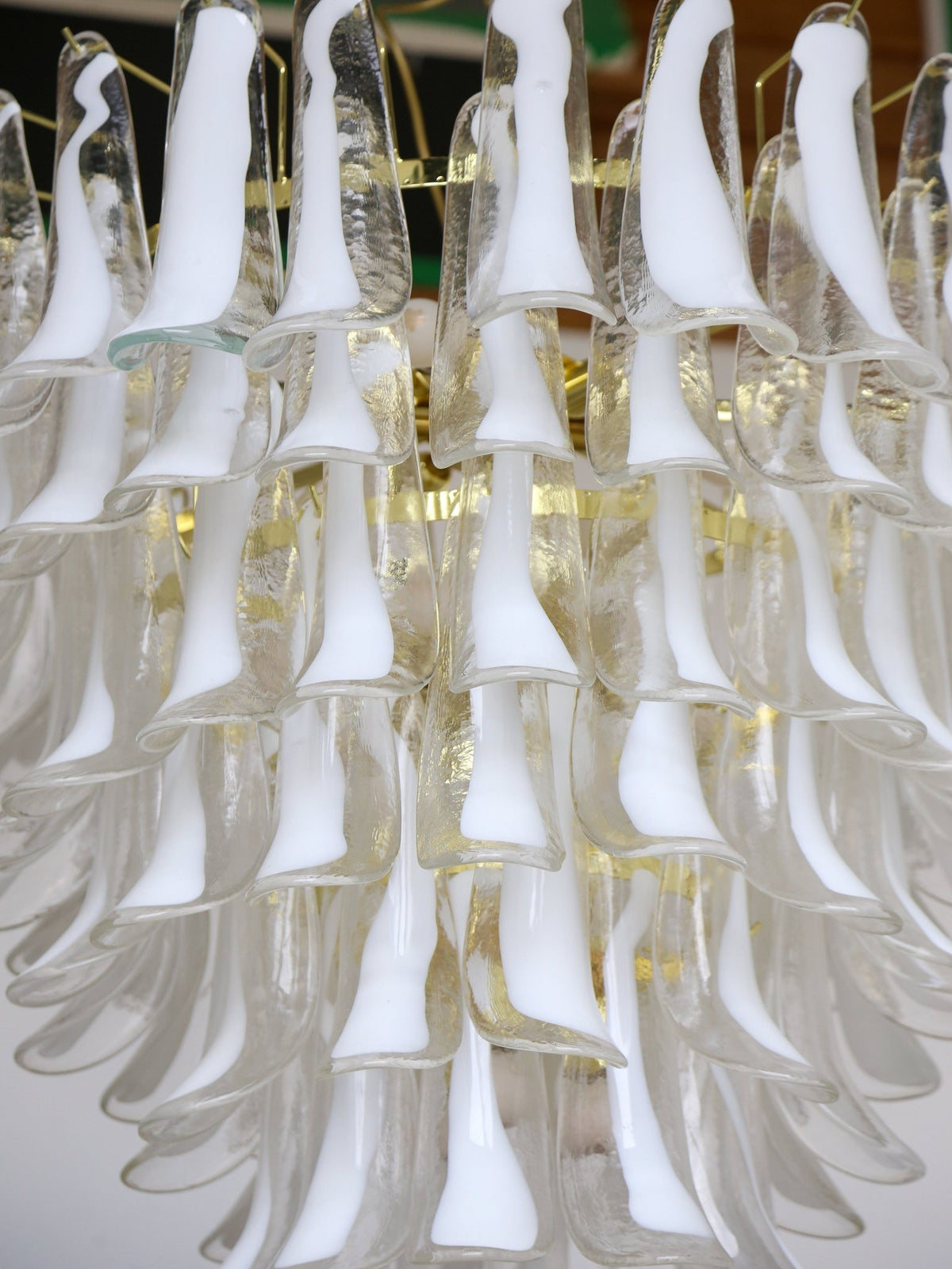 White glass chandelier with a gold frame