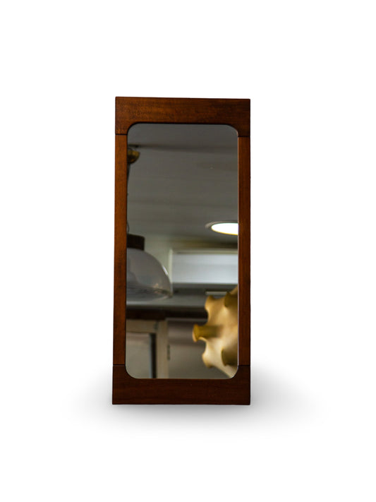 Wooden-framed mirror on a white background