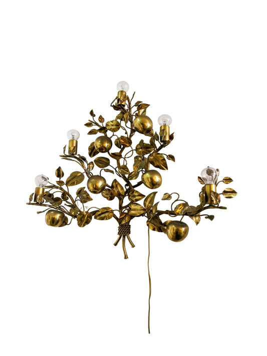 Decorative wall light fixture with gold leaf and fruit design on a white background