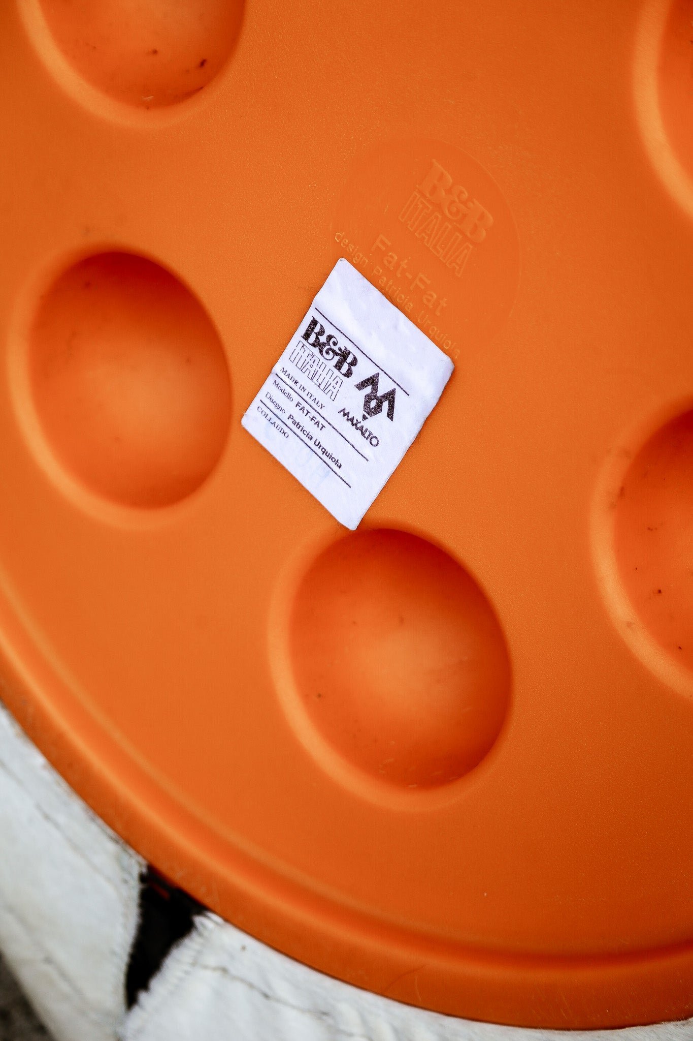 Orange lid with a label on a white background