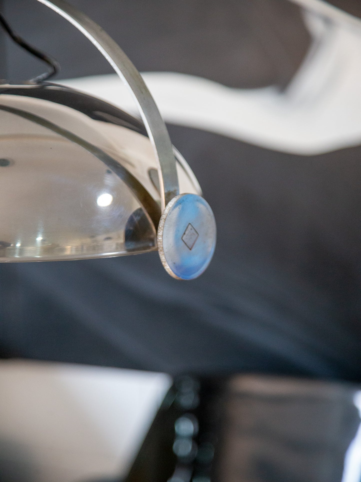 Close-up of brushed chrome hemisphere and engraved dial on Goffredo Reggiani light