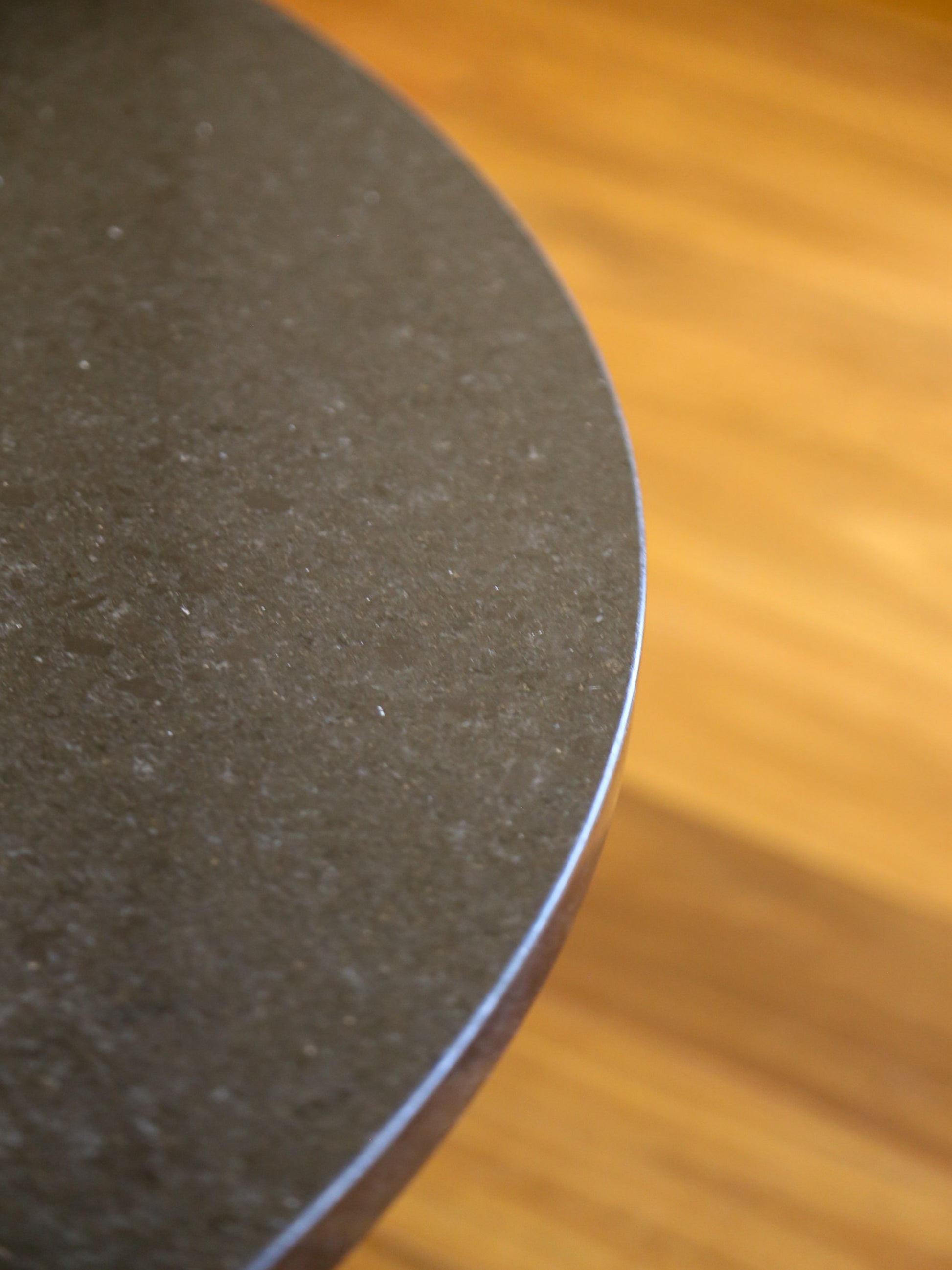 Close-up of a black circular object on a wooden surface