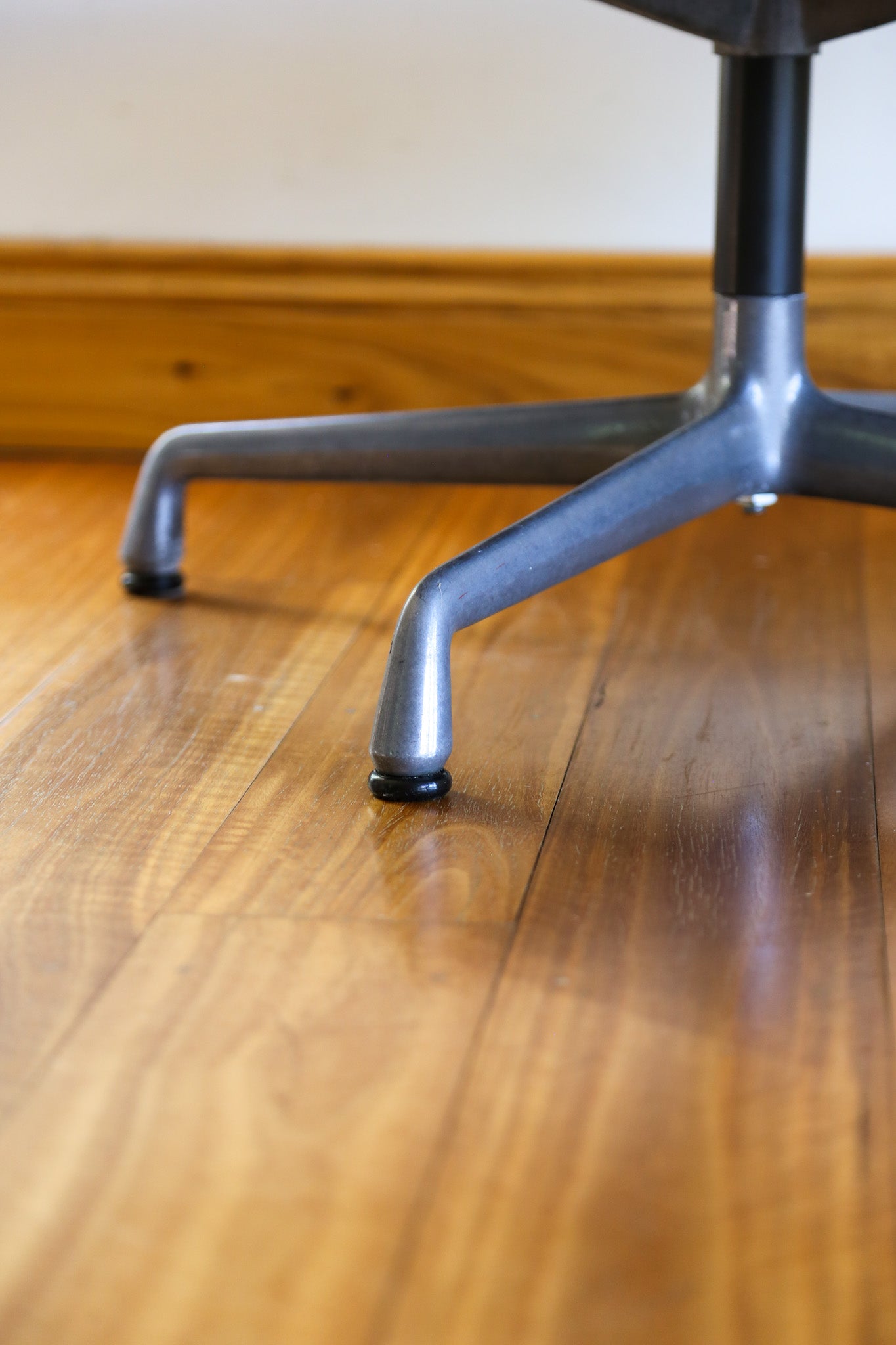 Close-up of a chair leg on a wooden floor