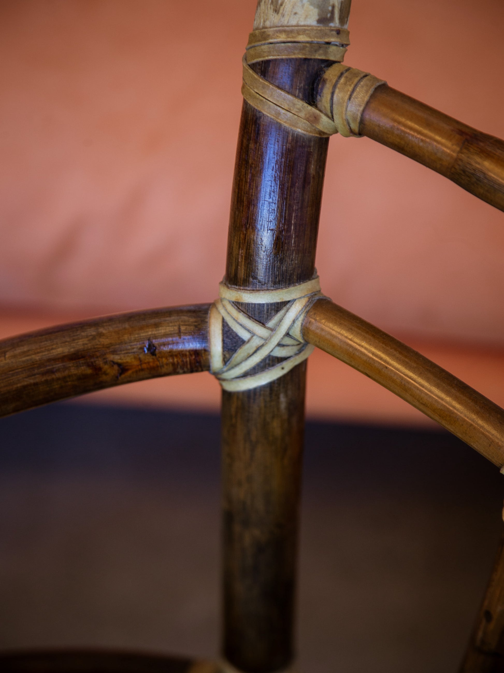 Close-up of a bamboo stick with woven string against a blurred background