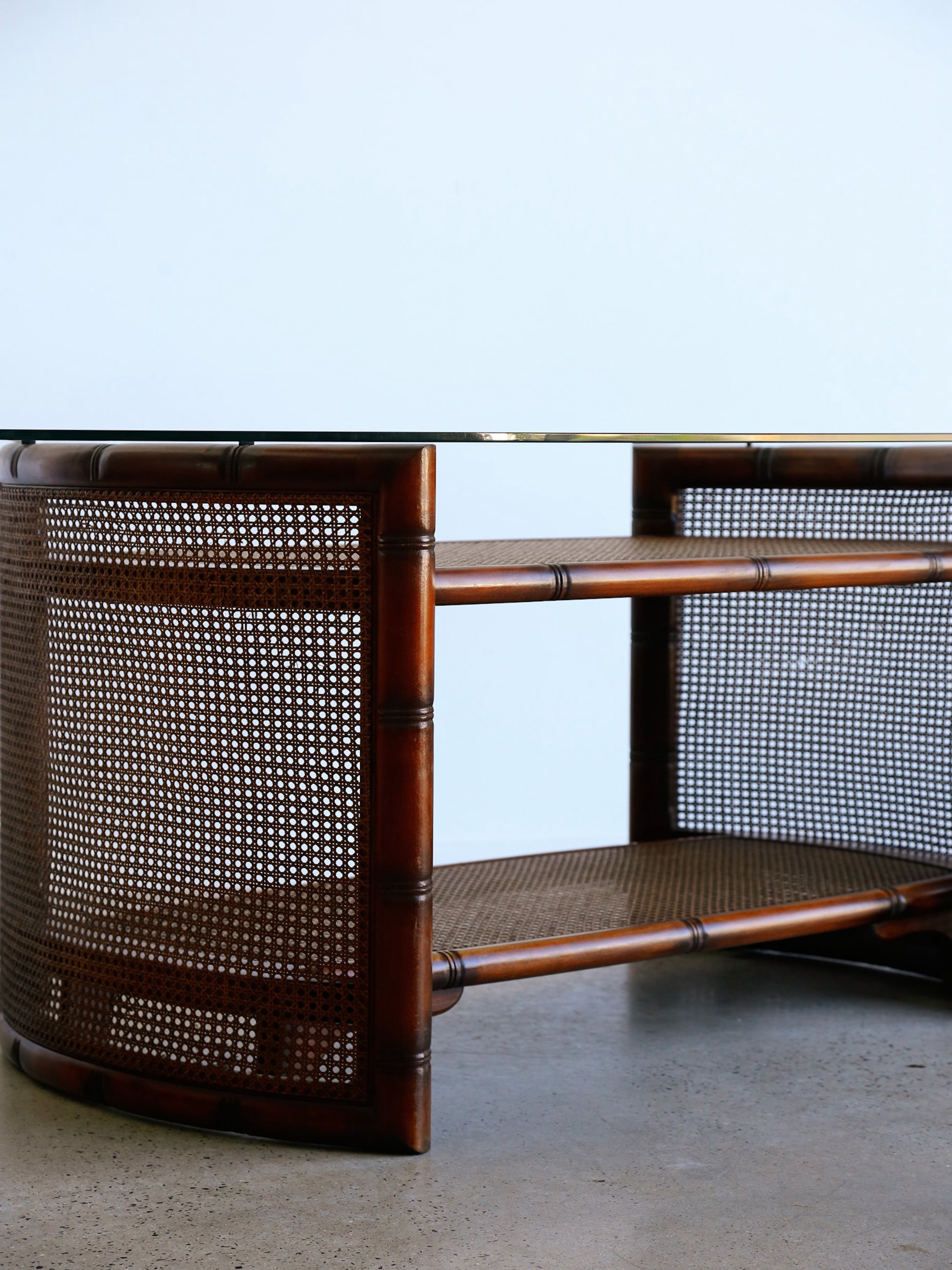 Rattan coffee table with woven design on a plain background