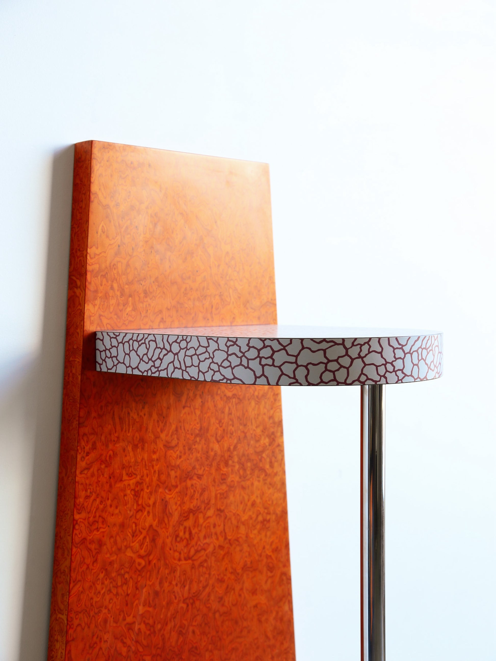 Decorative wall sconce with a textured brown shade and patterned metal fixture on a white background