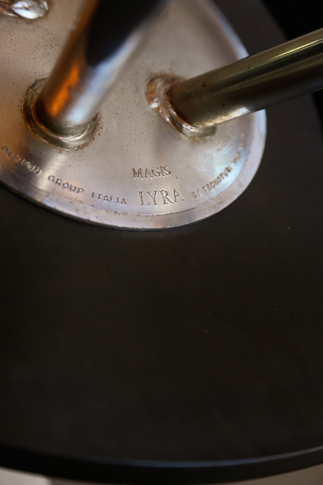 Close-up of a metallic object with 'LYRA' branding on a dark background