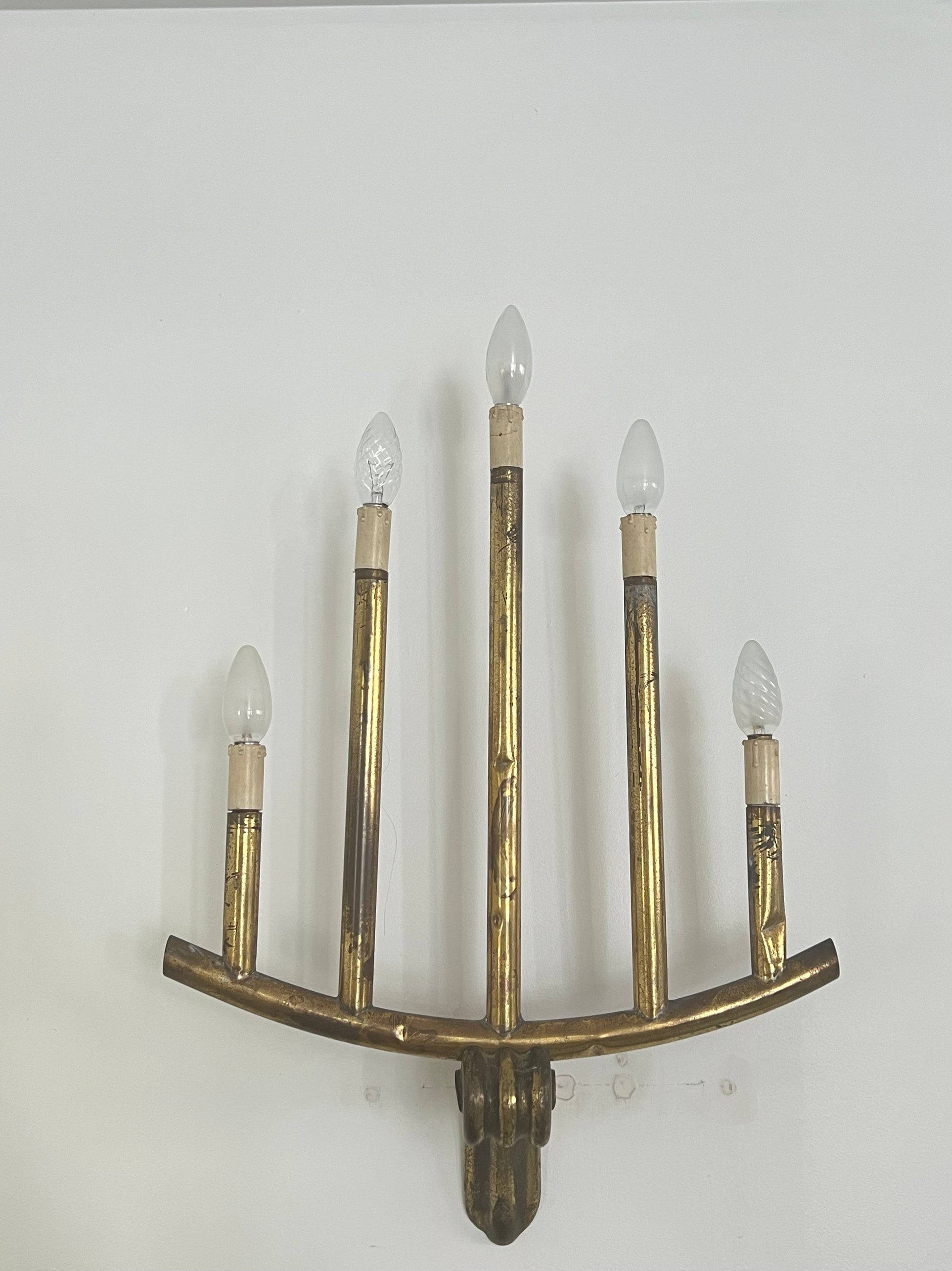 wall light with five bulbs over a white background