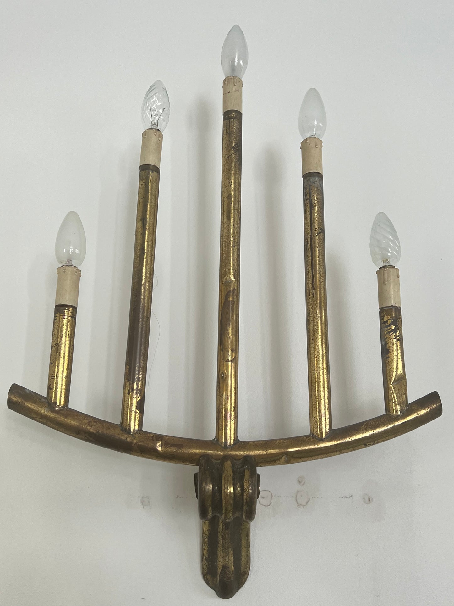 wall light with five bulbs over a white background