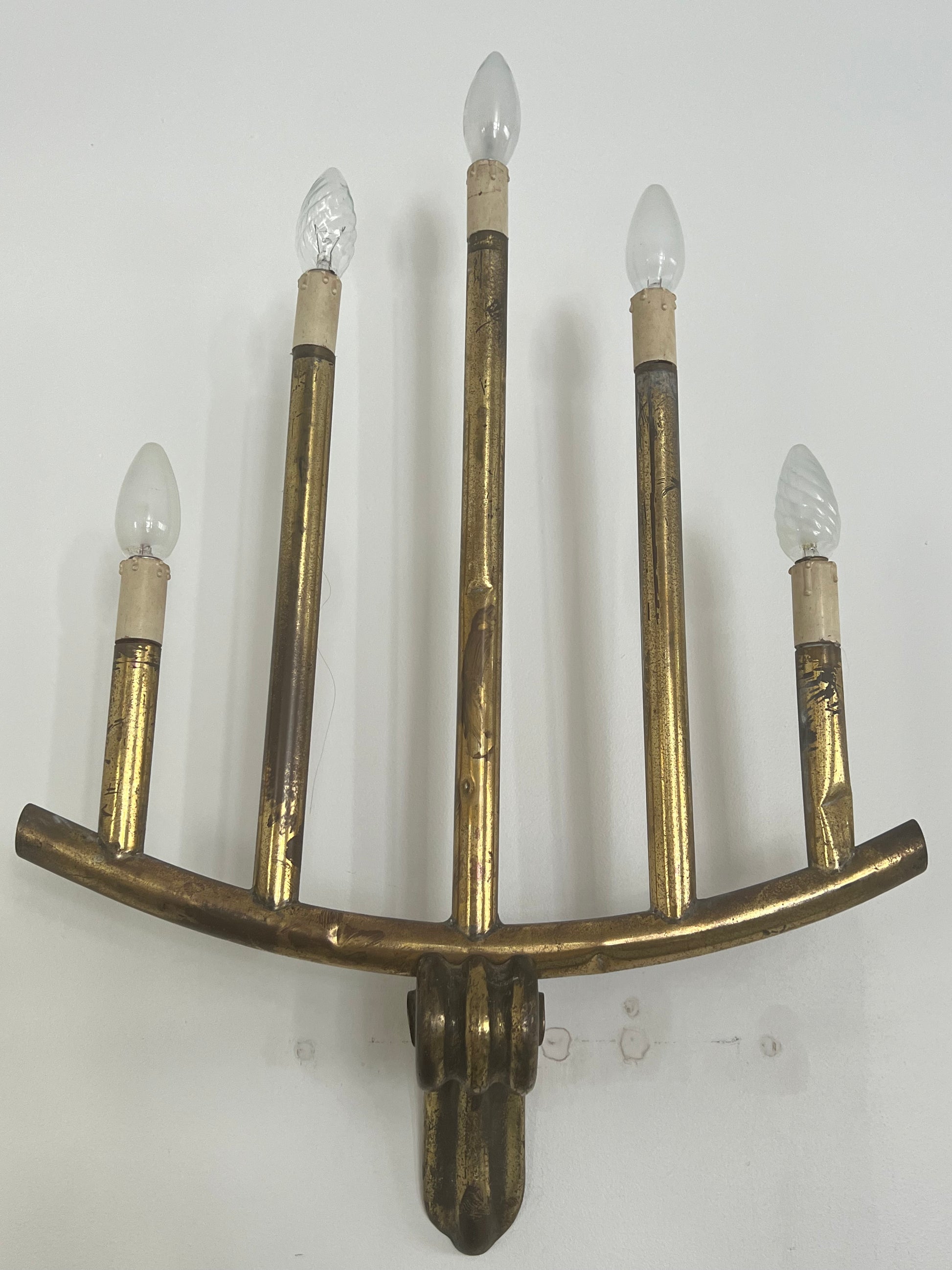 wall light with five bulbs over a white background
