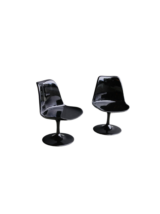 Two black chairs on a white background