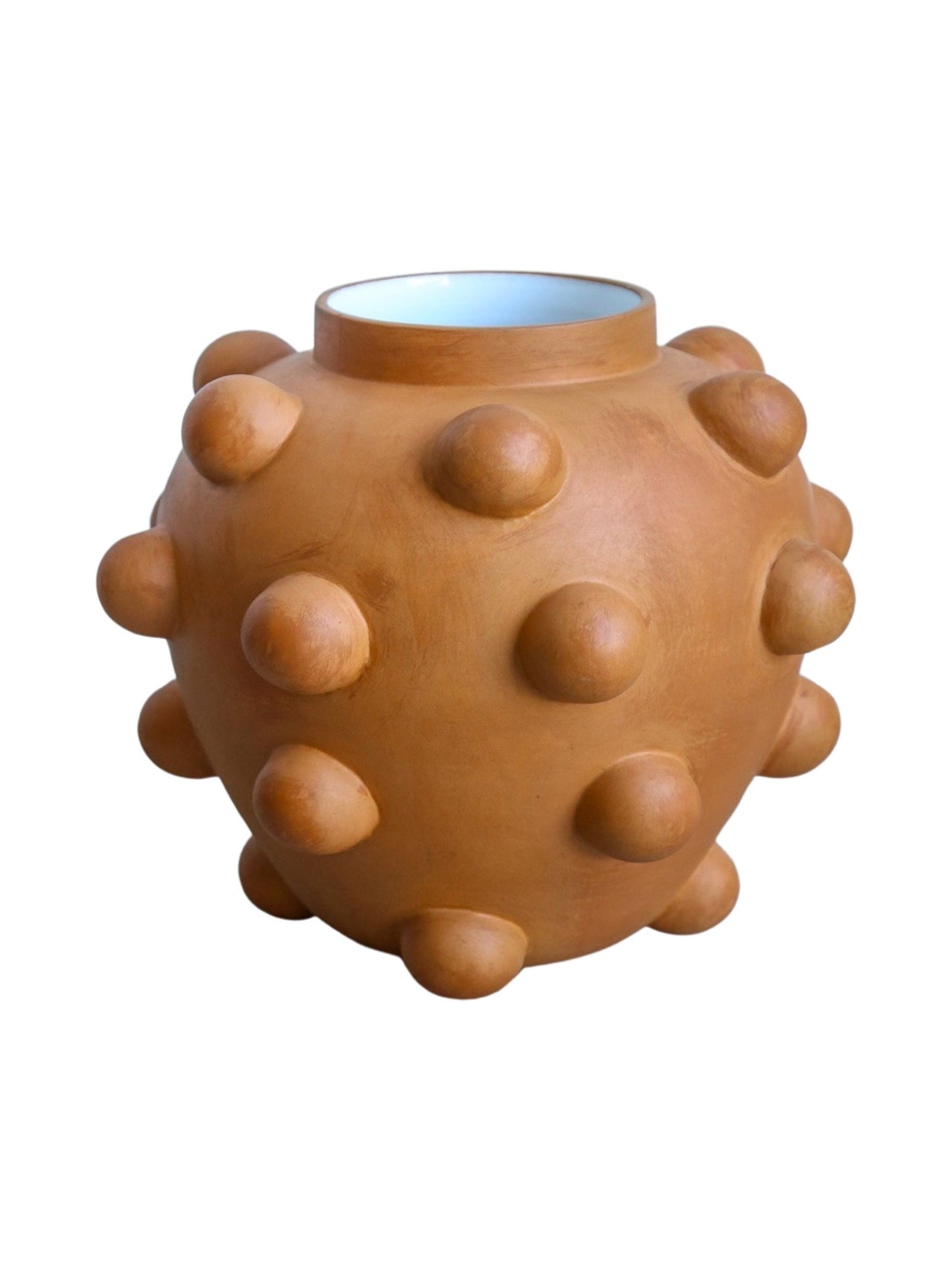 Terracotta-colored vase with bumpy texture on a white background