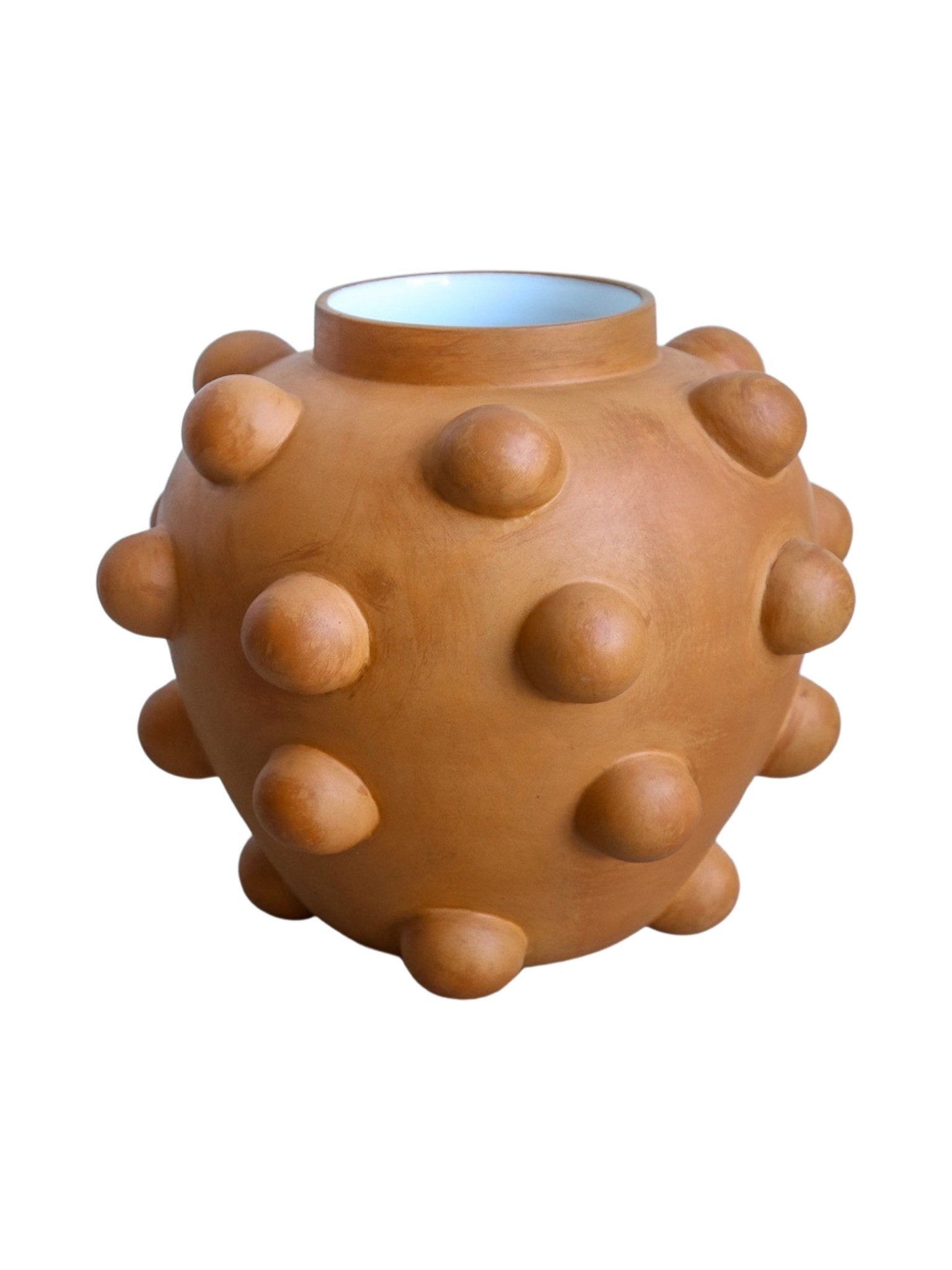 Terracotta-colored vase with bumpy texture on a white background