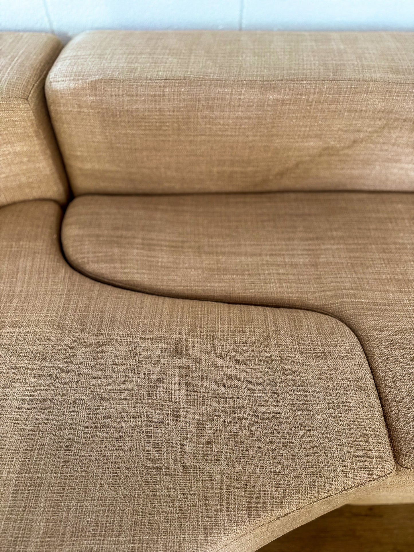 Beige sofa with a textured fabric pattern