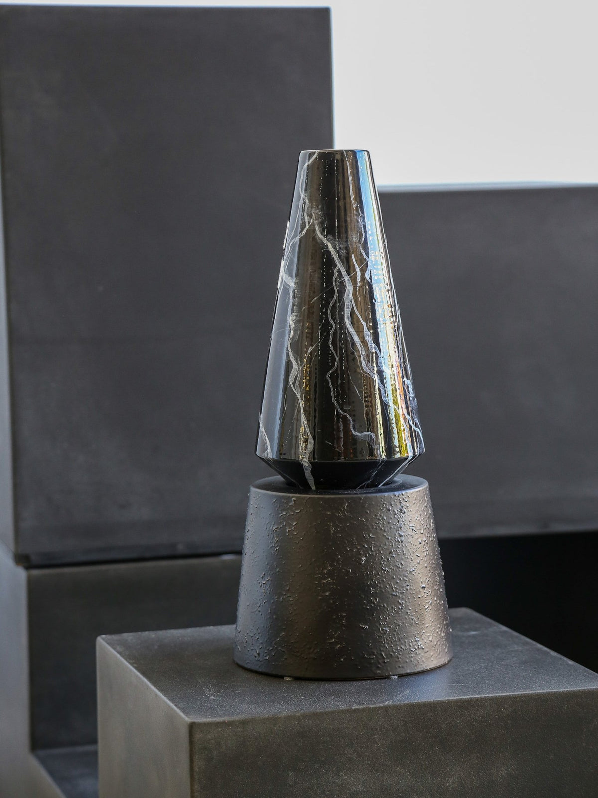 Decorative vase with marble-like pattern on a dark background