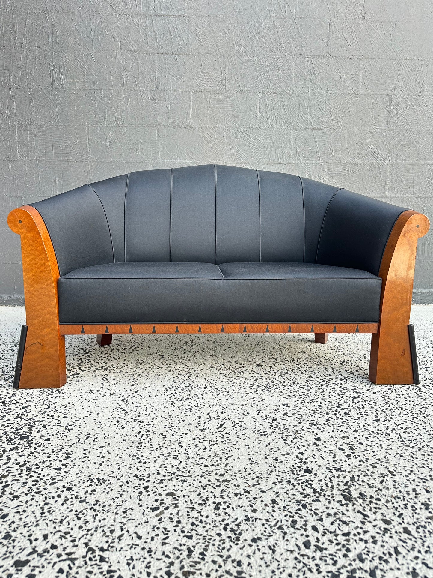 Detail of Michael Graves postmodern sofa, Italy 1980s, showing faceted birdseye maple frame and geometric ebony inlay