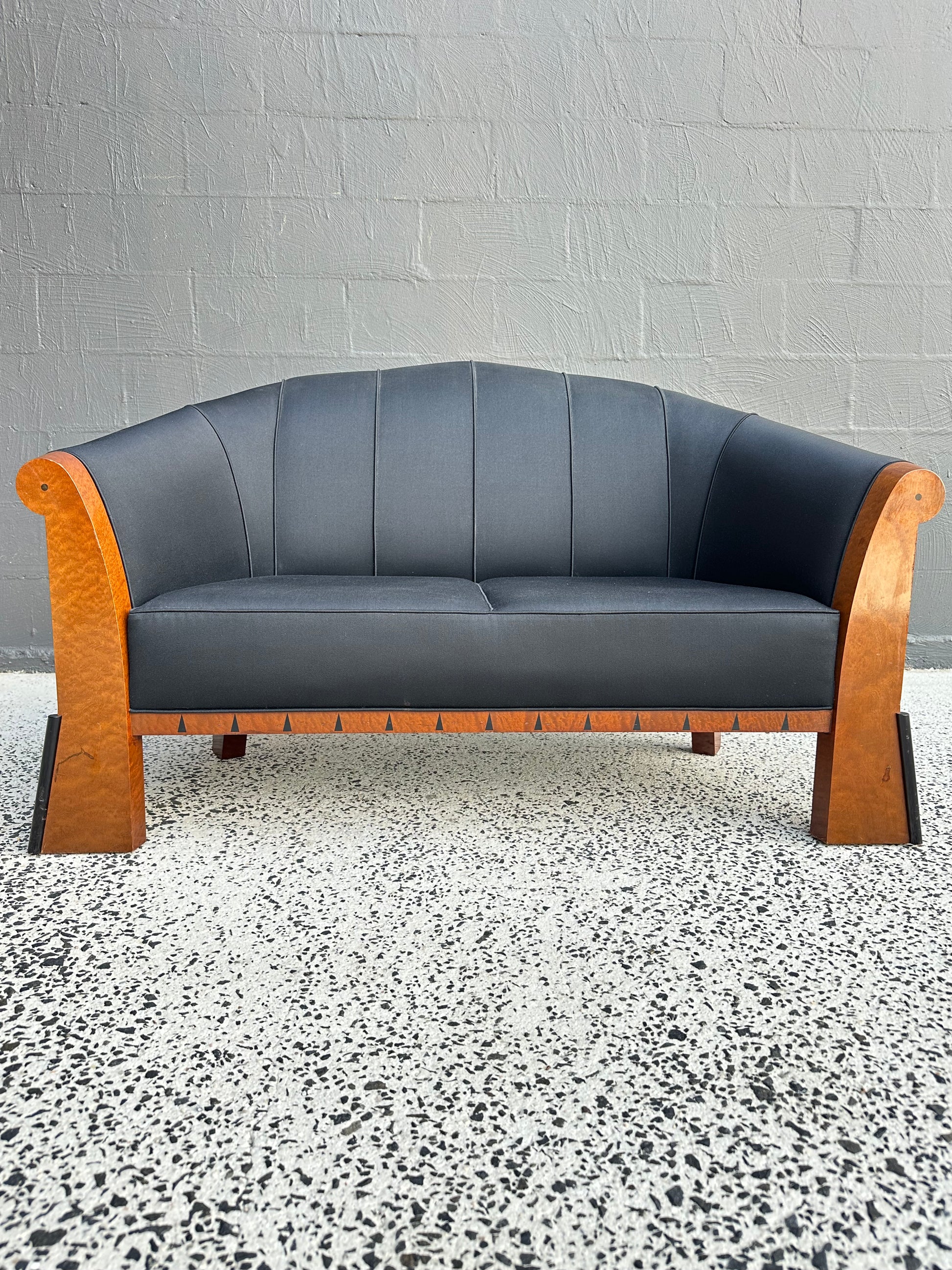 Detail of Michael Graves postmodern sofa, Italy 1980s, showing faceted birdseye maple frame and geometric ebony inlay