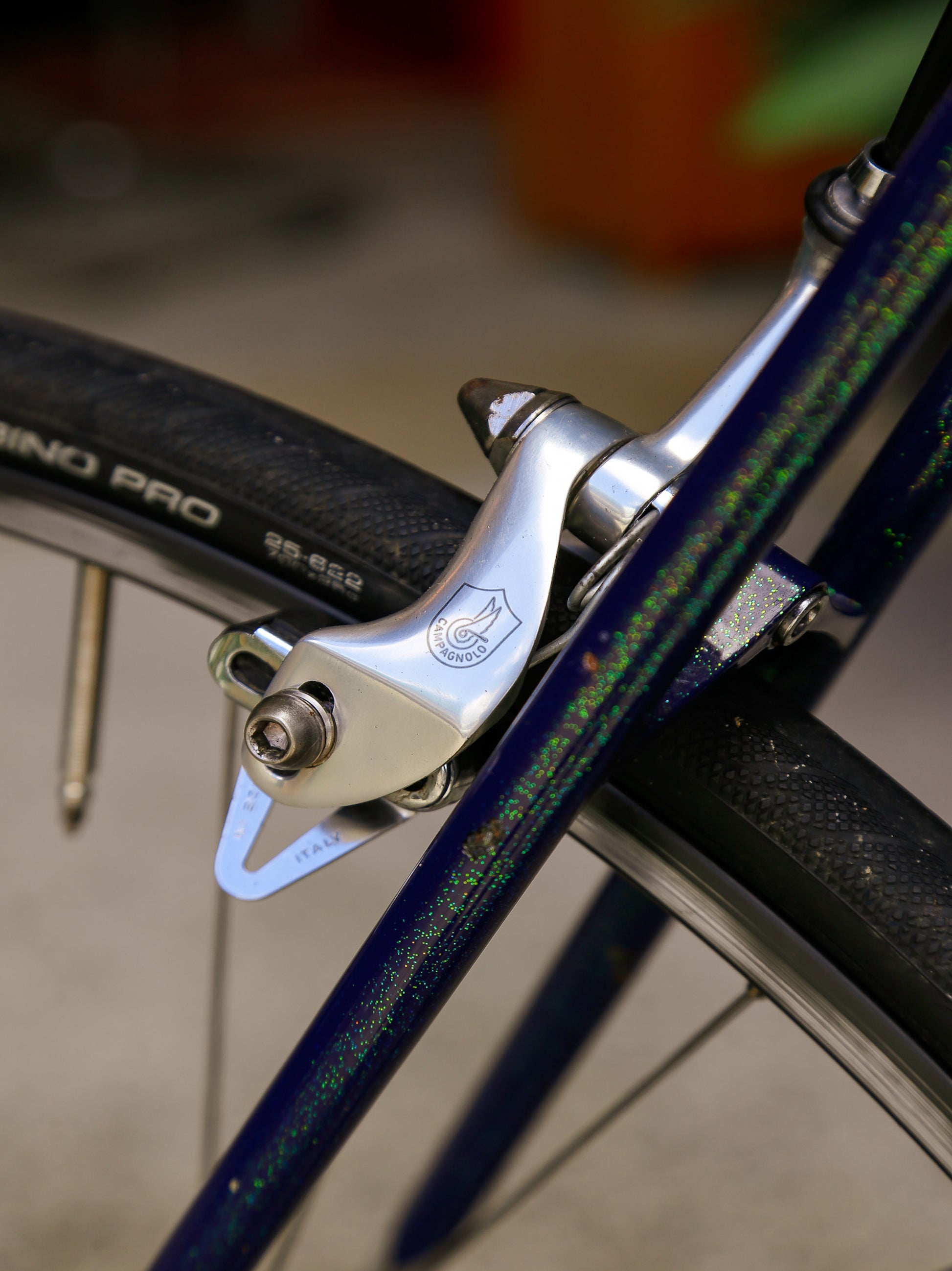 Close-up of a bicycle brake caliper with blurred background