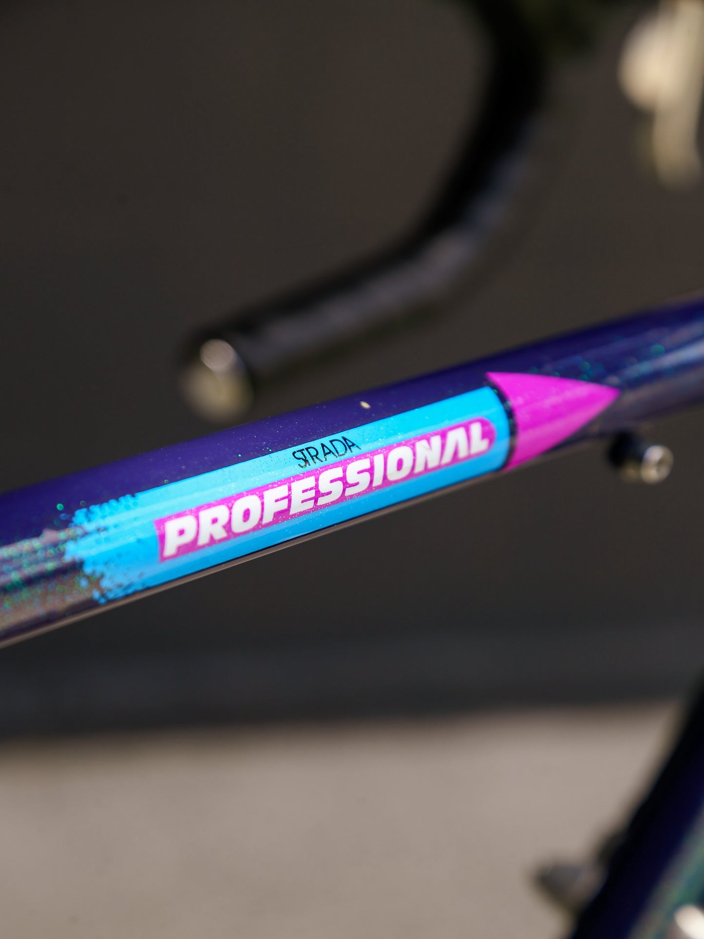 Close-up of a bicycle handlebar with 'Professional strada' branding.
