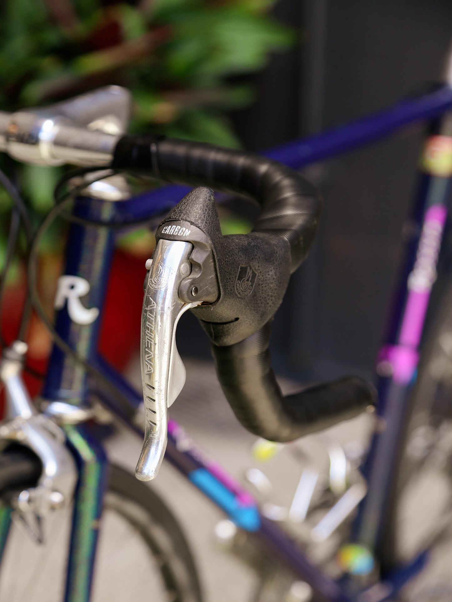 Close-up of bicycle handlebar with brake lever and gear shifter, blurred background
