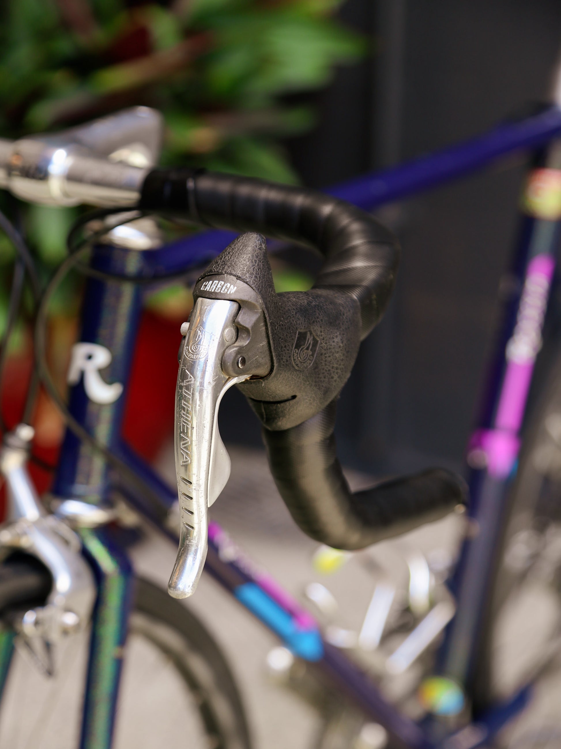 Close-up of bicycle handlebar with brake lever and gear shifter, blurred background