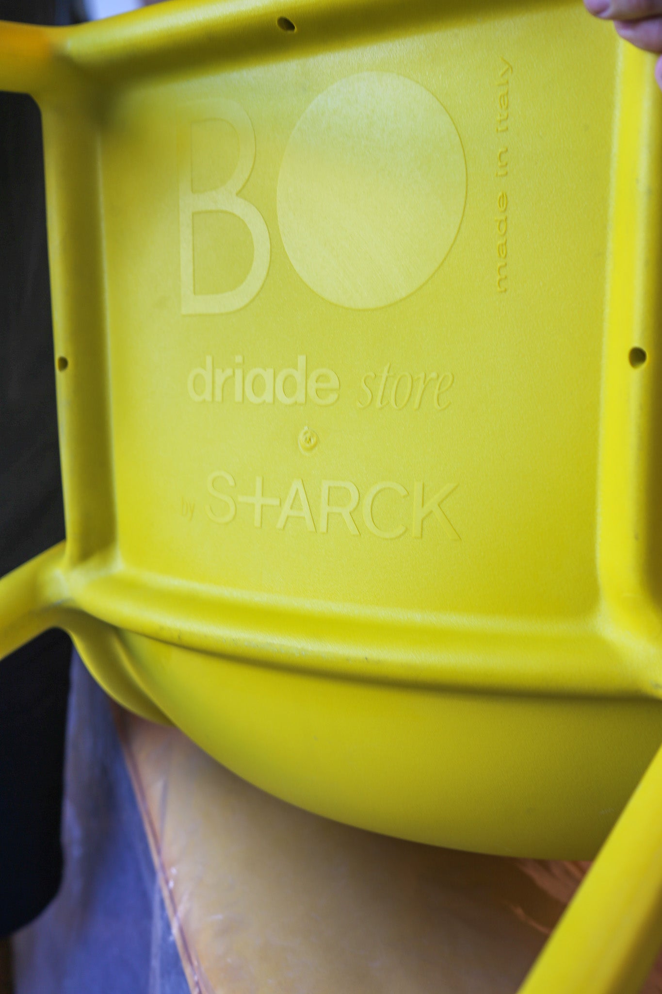 Yellow container with 'Bo' and 'Starck' branding on a blurred background
