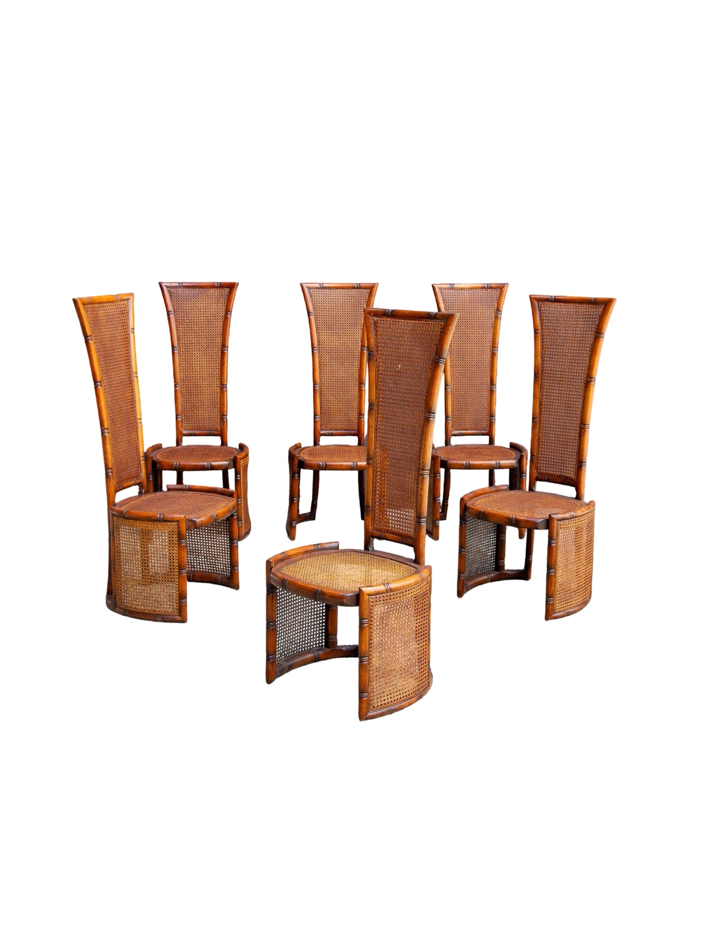 
Marzio Cecchi bamboo dining furniture featuring six high-back chairs with woven cane backs, three matching side tables, and one round coffee table, all in a warm brown finish on a white background.