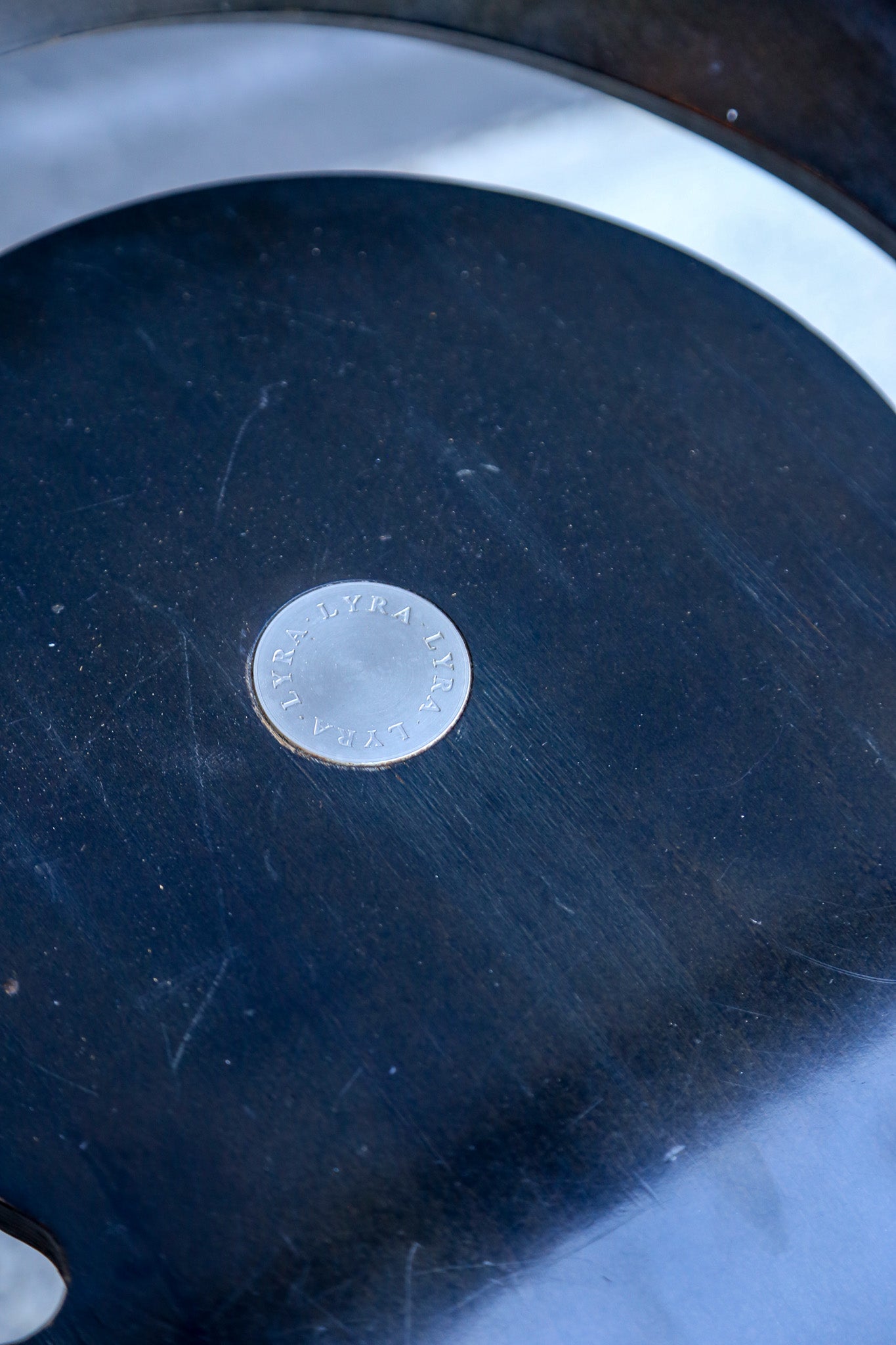 Silver coin on a dark surface with a blurred background